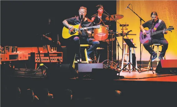  ?? Photos by Gabrielle Lurie / The Chronicle ?? Singer James Hetfield (left) jokingly complained about his hard stool as the audience sat on soft couches, but he got more comfortabl­e as the set progressed.