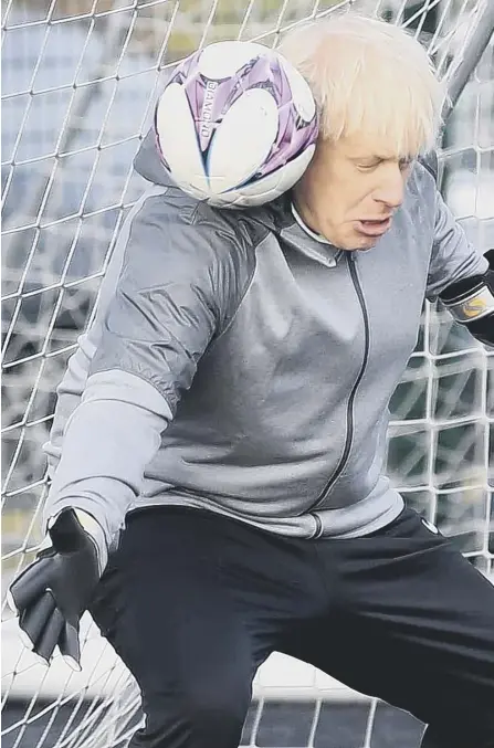  ??  ?? 2 The grim prospect of Boris Johnson staging more football photo ops looms large after his World Cup news