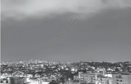  ?? AMIR COHEN/REUTERS ?? An anti-missile system seen from Ashkelon, Israel, operates Sunday after Iran launched drones and missiles toward Israel.