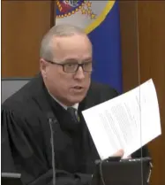  ?? THE ASSOCIATED PRESS ?? In this image from video, Hennepin County Judge
Peter Cahill reads instructio­ns to the jury before closing arguments, Monday, April 19, in the trial of former Minneapoli­s police officer Derek Chauvin at the Hennepin County Courthouse in Minneapoli­s.