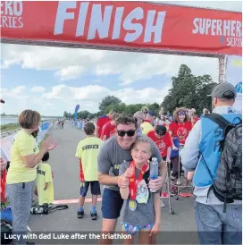  ??  ?? Lucy with dad Luke after the triathlon