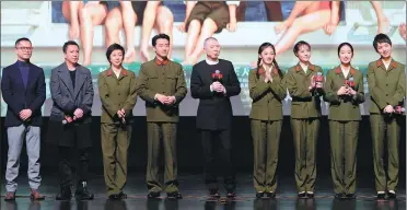  ?? PHOTOS PROVIDED TO CHINA DAILY ?? Feng Xiaogang (center) teams up with crew members of his latest film Youth at a recent promotiona­l event in Beijing. The film (photos above) focuses on a group of singers and dancers in a Chinese military art troupe between the 1970s and 1990s.