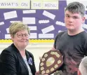  ??  ?? Well done Helen presents Marshall Laing with the inaugural Neil Thomson award for his work on the garden