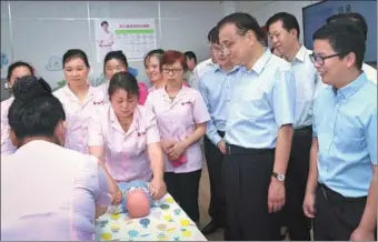  ?? RAO AIMIN / XINHUA ?? Premier Li Keqiang tours on Monday a section of 58.com that employs nannies. Online marketplac­e operator 58.com, in Changsha, Hunan province, offers services such as infant care, house-cleaning and moving through its online platform. The business...