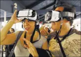  ?? AL SEIB/LOS ANGELES TIMES ?? Jenny Alvarez and Alfonso De Elias prepare to ride the Revolution virtual reality roller coaster at Magic Mountain.