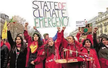  ?? Reuters ?? Demanding a say Representa­tives of indigenous peoples demonstrat­e in Paris yesterday. Poor countries have been ravaged by the effects of climate change and rising sea levels.