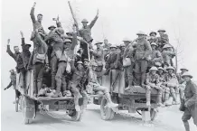  ?? DEPARTMENT OF NATIONAL DEFENCE/ LIBRARY AND ARCHIVES CANADA ?? Canadians who took part in taking Vimy Ridge return to billets on lorries.