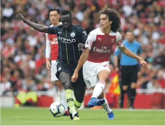  ?? Getty ?? Manchester City’s Benjamin Mendy, left, produced a strong-arm display against Arsenal on Sunday, when his runs down the left were a constant threat to Arsenal