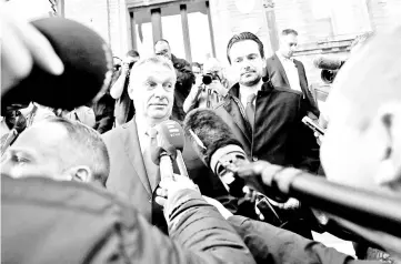  ??  ?? Orban gives a statement to the media after leaving a polling station during Hungarian parliament­ary election in Budapest. — Reuters photo