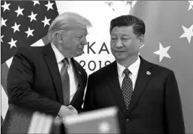  ??  ?? In this June 29 file photo, U.S. President Donald Trump (left) shakes hands with Chinese President Xi Jinping during a meeting on the sidelines of the G-20 summit in Osaka, western Japan. AP Photo/susAn WAlsh