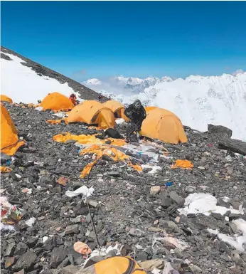  ?? AP PHOTO BY DAWA STEVEN SHERPA FOR ASIAN TREKKING ?? This photo taken on May 21st shows Camp Four, the highest camp on Mount Everest littered with abandoned tents. The record number of climbers on Mount Everest this season has left a cleanup crew grappling with how to clear away everything from abandoned tents to human waste that threatens drinking water.