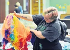  ?? PHOTOS: LINDA ROBERTSON ?? Something special . . . Communicat­ion and psychology student Theodora Morris (21) checks out a tutu at the University of Otago Drop for Good sale, at Smithells Gymnasium.