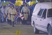  ?? AP/The Orange County Register/TERRY PIERSON ?? The casket of California Highway Patrol Officer Andrew Moye Jr. is transporte­d to a hearse from the Riverside University Health Systems Medical Center on Monday after he was shot and killed during a traffic stop in Moreno Valley, Calif.
