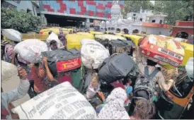  ?? ANI ?? Migrants gather at a railway station in Lucknow after Uttar Pradesh announced its decision to extend the lockdown by another week, on Sunday.