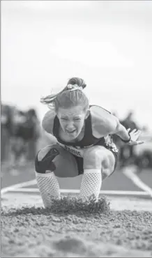  ?? MICHAEL J. BRETHOUR, SPECIAL TO THE RECORD ?? Nicole Paine of Galt Collegiate Institute and Vocational School lands a successful leap after an attempt at the midget girls’ long jump.