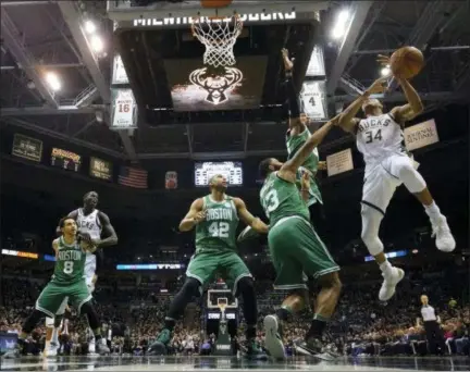  ?? MORRY GASH - THE ASSOCIATED PRESS ?? Milwaukee Bucks’ Giannis Antetokoun­mpo is fouled during the first half of Game 6of an NBA basketball first-round playoff series against the Boston Celtics Thursday, April 26, 2018, in Milwaukee.