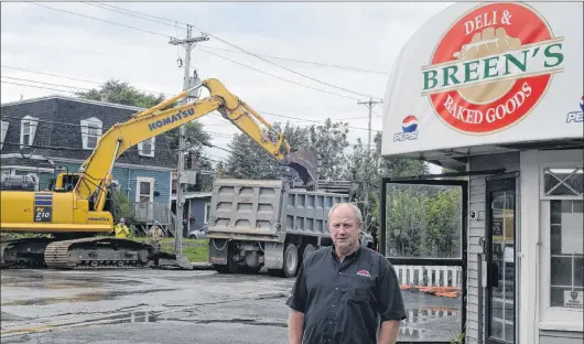  ?? JOE GIBBONS/THE TELEGRAM ?? Bill Breen, owner/operator of Breen’s Deli &amp; Baked Goods on the corner of Portugal Cove Road and Kerry Street, stands outside his store on Tuesday afternoon as work crews dig up the street to replace undergroun­d pipes.