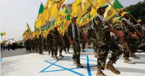  ?? (Thaier al-Sudani/Reuters) ?? IRANIAN-BACKED Iraqi Shi’ites wave Hezbollah flags and march on a painted Israeli flag to mark Quds Day in Baghdad.