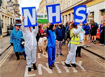  ?? Picture: Bath Campaigns ?? Campaigner­s raise their concerns about the Health and Care Bill at a march in Bath