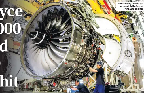  ??  ?? > Work being carried out on one of Rolls-Royce’s Trent XWB engines