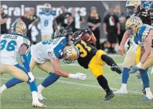  ?? BARRY GRAY THE HAMILTON SPECTATOR ?? Ticat Sean Thomas Erlington fights for yardage during first half action.
