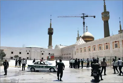  ?? PICTURE: AP ?? Police officers control the scene around the shrine of the late Iranian revolution­ary founder Ayatollah Khomeini, after two attacks in Tehran yesterday.