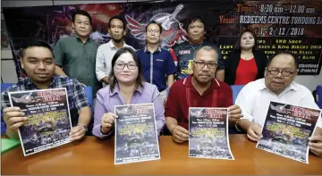  ?? — Photo by Chimon Upon ?? Juliet (seated, second left), Francis (seated left), Patrick (seated right) and other members of the organising committee hold up the fliers to promote ‘Rock Wheel 2018’.