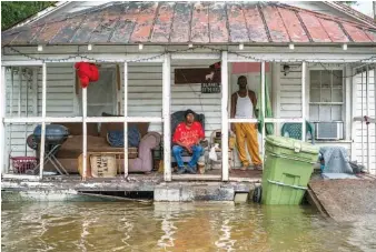  ?? JOHNNY MILANO/THE NEW YORK TIMES ?? Anthony Wheeler, right, and his sister Cynthia Warren sit at their home in Latta, S.C., on Sept. 16. Experts say global warming is bringing an era of wilder, more dangerous rains.