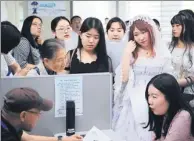  ?? CUI XIAO / FOR CHINA DAILY ?? Students, some in costume, attend a career fair in Nanjing, Jiangsu province, earlier this month.