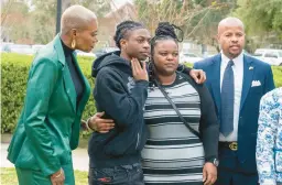  ?? KIRK SIDES/HOUSTON CHRONICLE ?? Darryl George, center, hugs his mother, Darresha, before a hearing Thursday in Anahuac, Texas, on his punishment for violating school dress code policy.