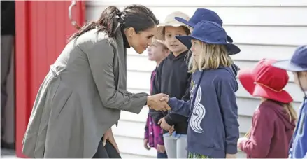  ?? Photo: Kesington Palace ?? The Duchess of Sussex speaking to young fans outside Maranui Cafe.