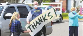  ?? Christian Abraham / Hearst Connecticu­t Media ?? Around 30 United Methodist Homes volunteers and administra­tors honor health care workers with a cheer line at Bishop Wicke nursing home in Shelton on May 14.