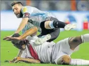  ?? AP ?? Lionel Messi is tackled by Peru's Wilder Cartagena.