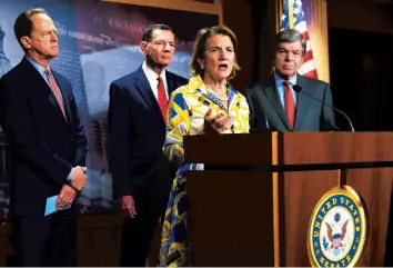  ?? J. SCOTT APPLEWHITE/AP ?? Sen. Shelley Moore Capito of West Virgina, the GOP’s lead negotiator on a counteroff­er to President Biden’s infrastruc­ture plan, speaks Thursday. Sens. Pat Toomey, R-Pa., left, John Barrasso, R-Wyo., and Roy Blunt, R-Mo., watch.