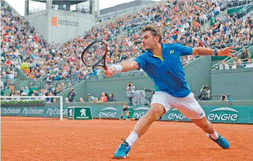  ?? AFP ?? Switzerlan­d’s Stanislas Wawrinka returns the ball to Italy’s Fabio Fognini during their match at the Roland Garros 2017 in Paris. —