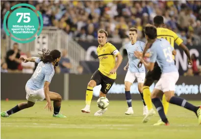  ?? AFP ?? Million dollars spent by City on Riyad Mahrez Mario Gotze of Borussia Dortmund chases the ball against Manchester City during the Champions Cup match in Chicago. —