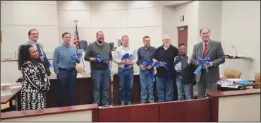  ?? ?? A delegation from Richland County Children Services was honored in Shelby where a proclamati­on was presented and blue ribbons presented.