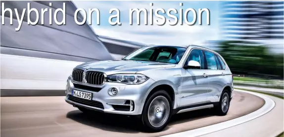  ?? PHOTOS COURTESY OF BMW ?? The BMW X5 is now available as a plug- in hybrid, called the xDrive40e, that can go up to 14 miles on electric power alone before the gasoline engine is required.