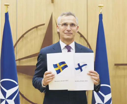  ?? ?? NATO Secretary-General Jens Stoltenber­g displays documents as Sweden and Finland apply for membership in Brussels, Belgium, May 18, 2022.