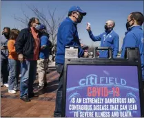  ?? THE ASSOCIATED PRESS ?? Fans arrive for COVID-19 screenings before entering Citifield before New York Mets home opening baseball game against the Miami Marlins, Thursday, April 8, 2021, in New York.