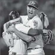  ?? Associated Press ?? No-hitter: In this April 21, 2018, file photo, Oakland Athletics starting pitcher Sean Manaea, right, celebrates with catcher Jonathan Lucroy after pitching a no-hitter against the Boston Red Sox in Oakland, Calif.
