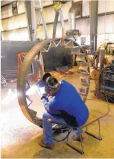  ?? ADOLPHE PIERRE-LOUIS/JOURNAL ?? An employee at CEMCO’s plant in Belen works on a rotor for the company’s stonecrush­ing machine. The company is selling crushers in more than two dozen countries worldwide.