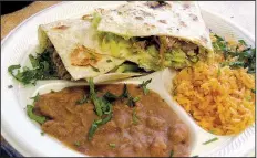  ?? Arkansas Democrat-Gazette/ROSEMARY BOGGS ?? Taqueria El Primo in Sherwood serves quesadilla­s filled with one’s choice of meat, lettuce, cheese, tomato and avocado. Here it’s made with carnitas, along with rice and beans.