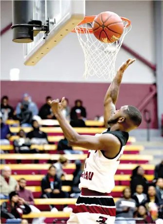  ?? Staff photo by Hunt Mercier ?? ■ Liberty-Eylau’s Dominique Williams goes for a layup after breaking away from Pittsburg defenders Friday at the Rader Dome. The Pirates won in overtime, 84-83.