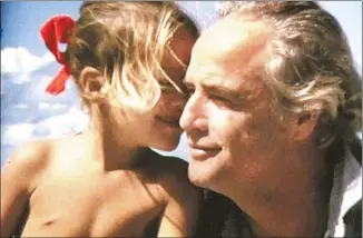  ?? Mike Gillman
Showtime ?? MARLON BRANDO shares a moment with his daughter Cheyenne in “Listen to Me Marlon.”