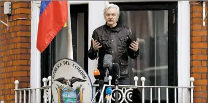  ?? The Associated Press ?? ASSANGE: WikiLeaks founder Julian Assange gestures as he speaks on the balcony Friday of the Ecuadorian embassy in London. Assange has won his battle against extraditio­n to Sweden, which wanted to question him about a rape allegation. He has spent...