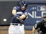  ?? AP/AARON GASH ?? Mike Moustakas hits a walk-off single in the 10th inning to lift the Milwaukee Brewers to a 3-2 victory over the Colorado Rockies on Thursday in the opening game of the National League division series in Milwaukee.