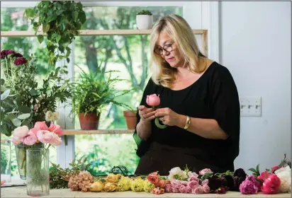  ?? Photos by Jennifer Heffner/The Washington Post ?? Above, Holly Chapple lays out and inspects each flower that goes into a bridal bouquet, while working on May 11, 2018, in her floral design studio in Loudoun County, Virginia. Below, Valerie Powell in a Holly Heider Chapple-designed floral hat, is a...