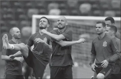  ?? The Associated Press ?? SPEEDY SILVA: Spain’s David Silva, center, exercises with teammates during Spain’s official training ahead of the round of 16 match between Russia and Spain at the 2018 World Cup at Luzhniki Stadium in Moscow Saturday. Silva’s speed will be crucial...