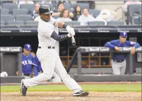  ?? Bill Kostroun / Associated Press ?? The New York Yankees’ Miguel Andujar hits a two-run home run during the seventh inning against the Texas Rangers on Saturday.